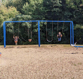 students on a swingset