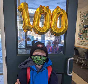 Student with number 100 balloons